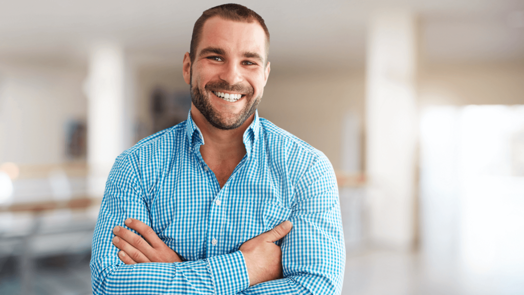 A smiling man feeling optimistic about his slip, trip, and fall claim.