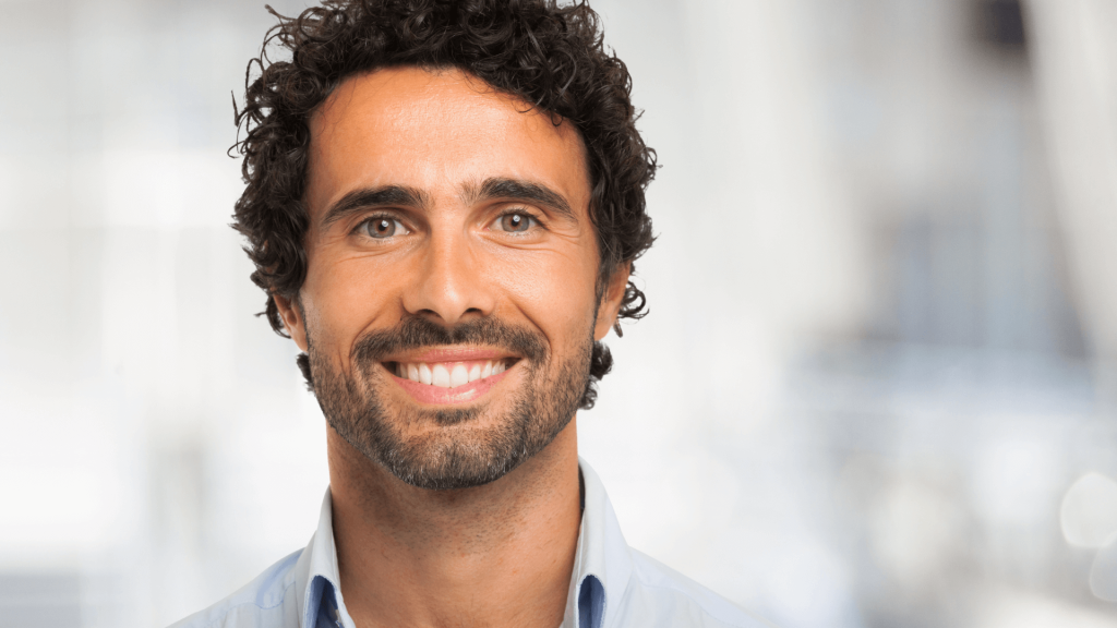 A smiling man confidently reviewing his slip, trip, and fall claim.