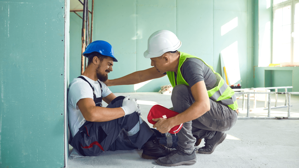 a man helping his colleague after he has sufered an injury at work