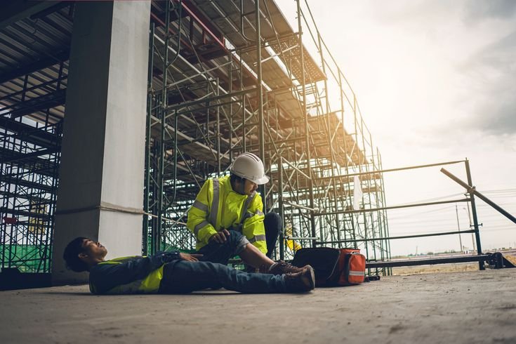 a worker lying on the ground after falling off scaffolding